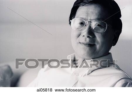 Man sitting in living room, portrait View Large Photo Image Stock Photo - Man sitting in living room, portrait. Fotosearch