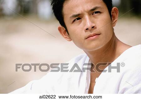 Man sitting on beach looking away View Large Photo Image Stock Image - Man sitting on beach looking away. Fotosearch