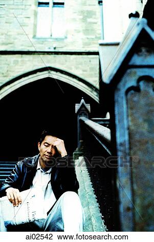 Man sitting on stairs with hand on forehead View Large Photo Image Stock Image - Man sitting on stairs with hand on forehead. Fotosearch