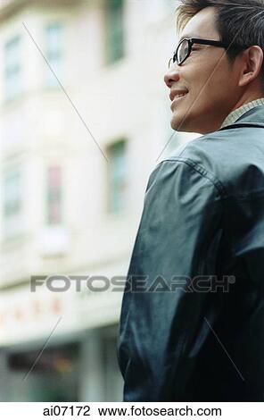 Stock Image - Man smiling, looking. Fotosearch