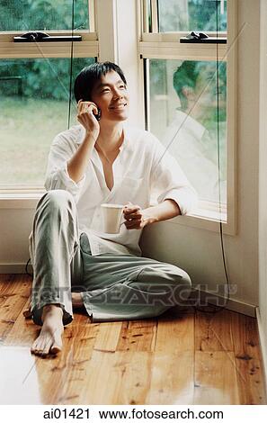 Man using cellular phone in front of window View Large Photo Image Stock Image - Man using cellular phone in front of window. Fotosearch