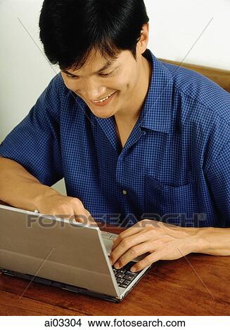 Picture - Man using laptop. Fotosearch