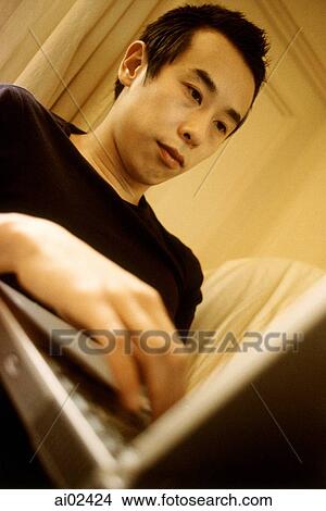 Picture - Man using laptop, view from below.. Fotosearch