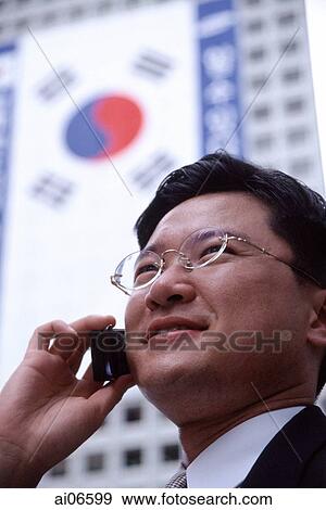 Stock Photo - Man using mobile phone, head shot. Fotosearch