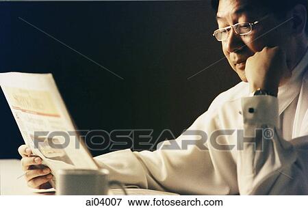 Man wearing glasses reading newspaper ( high grain) View Large Photo Image Stock Photo - Man wearing glasses reading newspaper ( high grain). Fotosearch