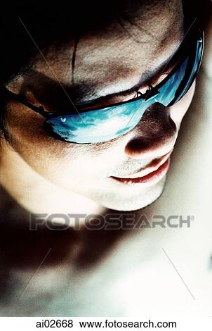 Man wearing sunglasses, elevated view View Large Photo Image Stock Photo - Man wearing sunglasses, elevated view. Fotosearch
