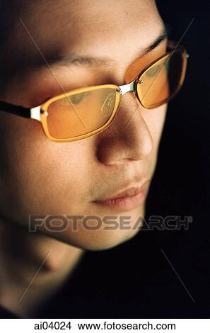 Man wearing tinted glasses, side profile, black background View Large Photo Image Picture - Man wearing tinted glasses, side profile, black background. Fotosearch