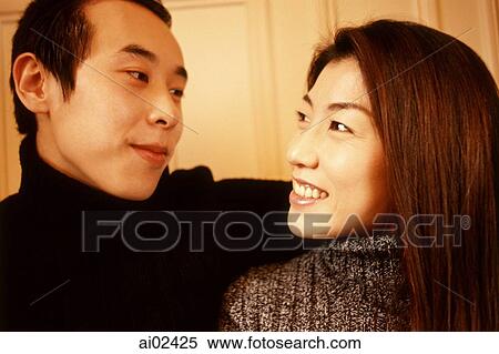 Man with arm around woman, looking at each other. View Large Photo Image Stock Photography - Man with arm around woman, looking at each other.. Fotosearch