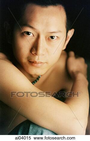 Man with arm wrapped around himself, portrait View Large Photo Image Stock Photography - Man with arm wrapped around himself, portrait. Fotosearch