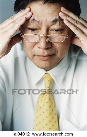 Man with fingers on temples View Large Photo Image Stock Image - Man with fingers on temples. Fotosearch