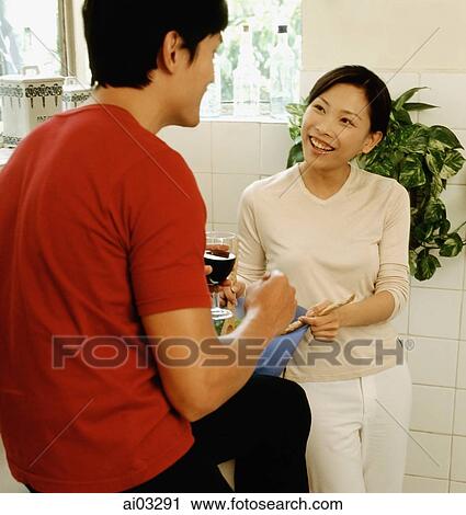 Man with wine glass talking to woman View Large Photo Image Stock Image - Man with wine glass talking to woman. Fotosearch