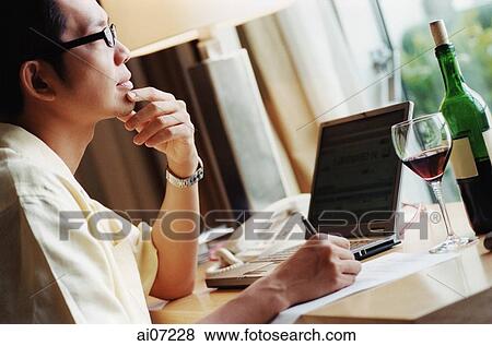 Man working at desk, looking pensive. View Large Photo Image Stock Photo - Man working at desk, looking pensive.. Fotosearch