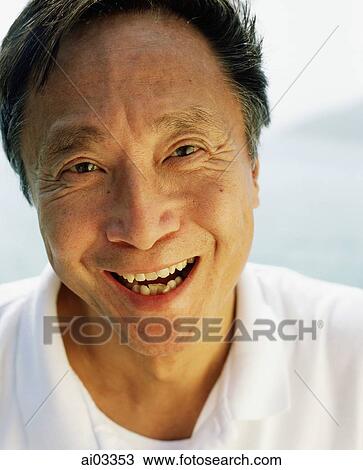 Stock Image - Mature man laughing, portrait. Fotosearch