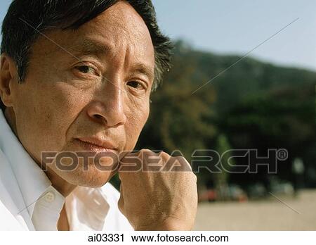 Stock Image - Mature man outdoors, portrait. Fotosearch