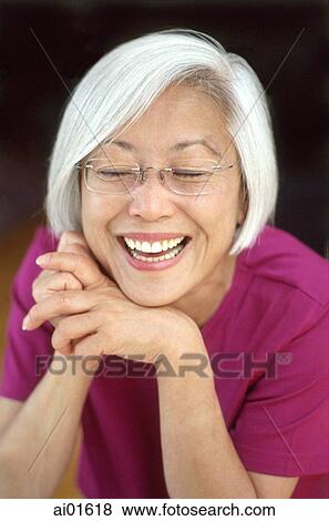 Mature woman leaning chin on hands, laughing, portrait View Large Photo Image Stock Photo - Mature woman leaning chin on hands, laughing, portrait. Fotosearch