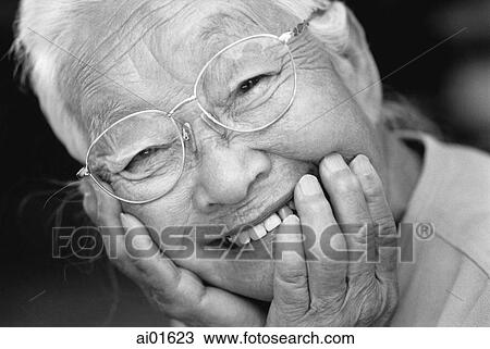 Mature woman resting chin on hands, smiling, portrait View Large Photo Image Stock Image - Mature woman resting chin on hands, smiling, portrait. Fotosearch