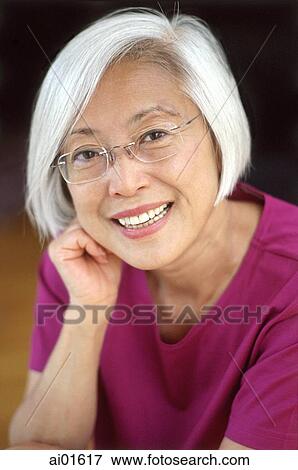 Mature woman with glasses resting head on fist, portrait View Large Photo Image Stock Photo - Mature woman with glasses resting head on fist, portrait. Fotosearch