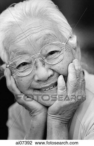 Mature woman with glasses, with hands on head, smiling. View Large Photo Image Stock Image - Mature woman with glasses, with hands on head, smiling.. Fotosearch