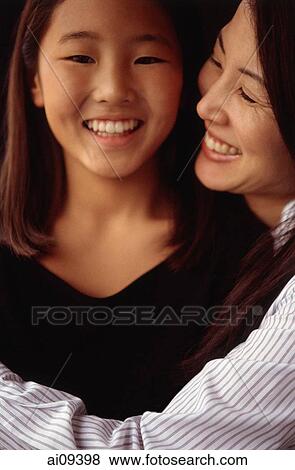 Mother and daughter hugging and smiling View Large Photo Image Stock Photo - Mother and daughter hugging and smiling. Fotosearch