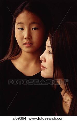 Mother and daughter, looking at camera and looking away View Large Photo Image Picture - Mother and daughter, looking at camera and looking away. Fotosearch
