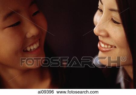 Mother and daughter looking at each other and smiling View Large Photo Image Stock Photograph - Mother and daughter looking at each other and smiling. Fotosearch