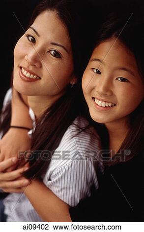 Stock Image - Mother and daughter, smiling, hugging. Fotosearch