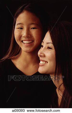 Mother and daughter, smiling, portrait View Large Photo Image Stock Image - Mother and daughter, smiling, portrait. Fotosearch