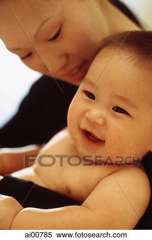 Mother looking at baby boy (3-9 months old) smiling View Large Photo Image Stock Photography - Mother looking at baby boy (3-9 months old) smiling. Fotosearch