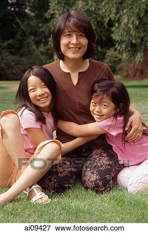 Mother with two daughters, looking at camera View Large Photo Image Stock Photo - Mother with two daughters, looking at camera. Fotosearch