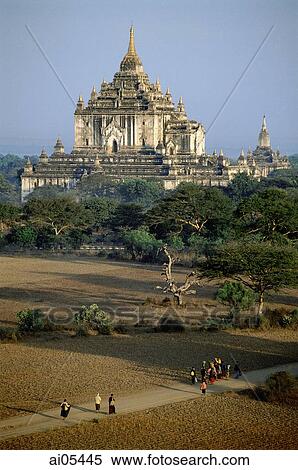 Myanmar (Burma), Bagan, Villagers walking along dirt roads with temples in backgrounds View Large Photo Image Stock Photography - Myanmar (Burma), Bagan, Villagers walking along dirt roads with temples in backgrounds. Fotosearch