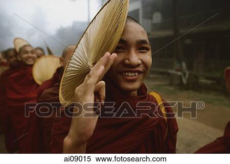 Myanmar (Burma), Bago, Buddhist monk holding a fan, in line to collect alms. View Large Photo Image Stock Photography - Myanmar (Burma), Bago, Buddhist monk holding a fan, in line to collect alms.. Fotosearch