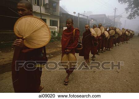 Myanmar (Burma), Bago, Buddhist monks holding fans line up to collect alms. View Large Photo Image Stock Image - Myanmar (Burma), Bago, Buddhist monks holding fans line up to collect alms.. Fotosearch