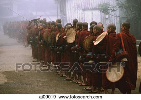 Myanmar (Burma), Bago, Buddhist monks with fans line up to collect alms. View Large Photo Image Stock Photo - Myanmar (Burma), Bago, Buddhist monks with fans line up to collect alms.. Fotosearch