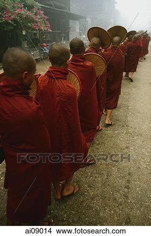 Picture - Myanmar (Burma), Bago, Line of Buddhist monks collecting alms.. Fotosearch