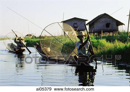Stock Photo - Myanmar (Burma), Fishermen in boats on Inle Lake. Fotosearch