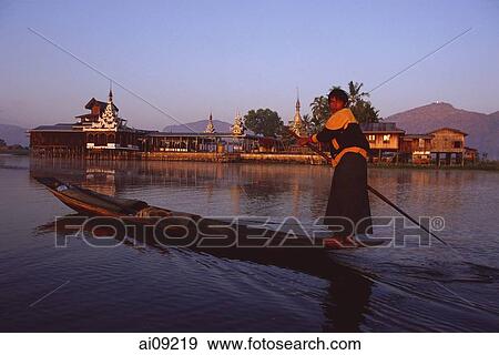 Stock Photo - Myanmar (Burma), Inle lake, Boatman in front of Nga Phe Kyaung monastery.. Fotosearch