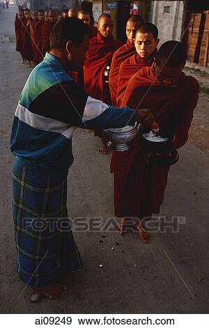 Myanmar (Burma), Inle lake, Buddhist monks receiving alms. View Large Photo Image Stock Photo - Myanmar (Burma), Inle lake, Buddhist monks receiving alms.. Fotosearch