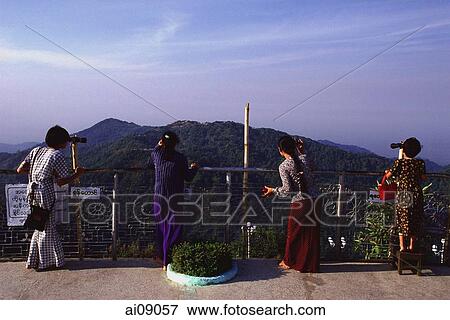 Myanmar (Burma), Kyaiktiyo, Teenage girls use telescopes at view point - 'golden rock'. View Large Photo Image Stock Photo - Myanmar (Burma), Kyaiktiyo, Teenage girls use telescopes at view point - 'golden rock'.. Fotosearch