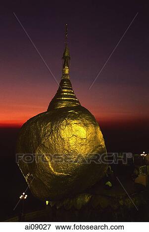 Myanmar (Burma), Kyaiktiyo, Worshippers at 'golden rock' at sunset. View Large Photo Image Stock Photo - Myanmar (Burma), Kyaiktiyo, Worshippers at 'golden rock' at sunset.. Fotosearch