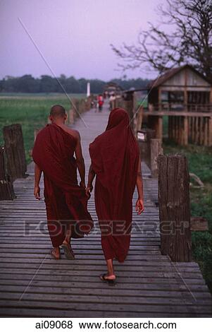 Myanmar (Burma), Mandalay, Buddhist monks crossing the U Bein bridge. View Large Photo Image Stock Photo - Myanmar (Burma), Mandalay, Buddhist monks crossing the U Bein bridge.. Fotosearch