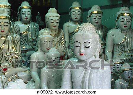 Stock Image - Myanmar (Burma), Mandalay, Marble Buddha statuettes on display in roadside stall.. Fotosearch