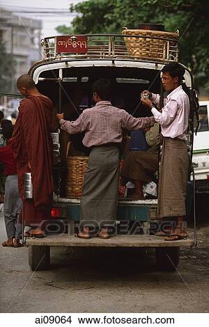 Myanmar (Burma), Mandalay, Men in longyis standing at back of public minivan. View Large Photo Image Picture - Myanmar (Burma), Mandalay, Men in longyis standing at back of public minivan.. Fotosearch