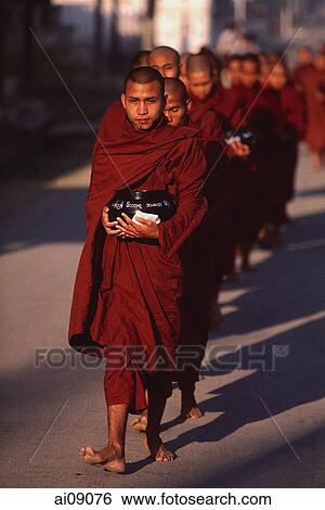 Stock Photograph - Myanmar (Burma), Nyaungshwe, Inle lake, Buddhist monks returning to monastery after collecting alms.. Fotosearch