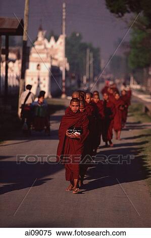 Myanmar (Burma), Nyaungshwe, Inle lake, Buddhist monks returning to monastery after collecting alms. View Large Photo Image Stock Photography - Myanmar (Burma), Nyaungshwe, Inle lake, Buddhist monks returning to monastery after collecting alms.. Fotosearch