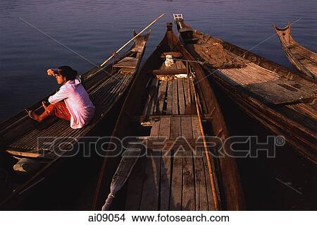 Picture - Myanmar (Burma), Pyay, Woman waiting on canoe on the Irrawaddy river.. Fotosearch