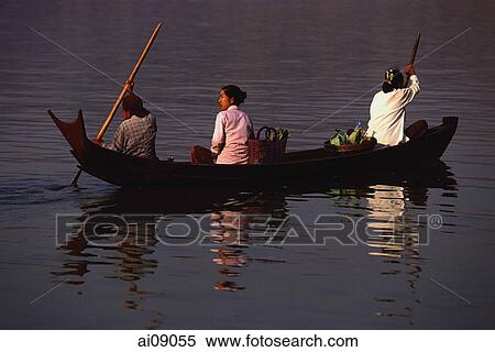 Stock Photography - Myanmar (Burma), Pyay, Women crossing Irrawaddy river in a canoe.. Fotosearch
