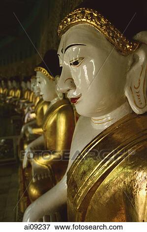 Myanmar (Burma), Sangaing Hills, Mandalay, Line of Buddha statues at Onhmin Thonze. View Large Photo Image Stock Photo - Myanmar (Burma), Sangaing Hills, Mandalay, Line of Buddha statues at Onhmin Thonze.. Fotosearch