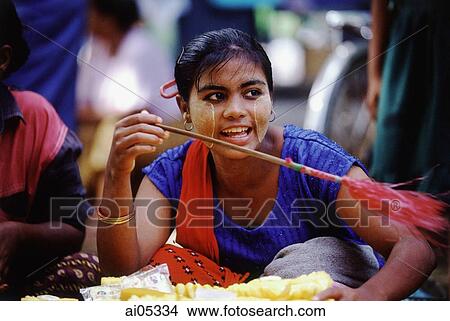 Myanmar (Burma), Yangon (Rangoon), A vendor in a market fanning the humid air to keep flies away from her sliced pineapple. View Large Photo Image Picture - Myanmar (Burma), Yangon (Rangoon), A vendor in a market fanning the humid air to keep flies away from her sliced pineapple.. Fotosearch