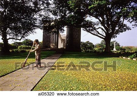 Myanmar (Burma), Yangon (Rangoon), A caretaker sweeping a path at the Htaukkyant War Cemetery. View Large Photo Image Stock Image - Myanmar (Burma), Yangon (Rangoon), A caretaker sweeping a path at the Htaukkyant War Cemetery.. Fotosearch