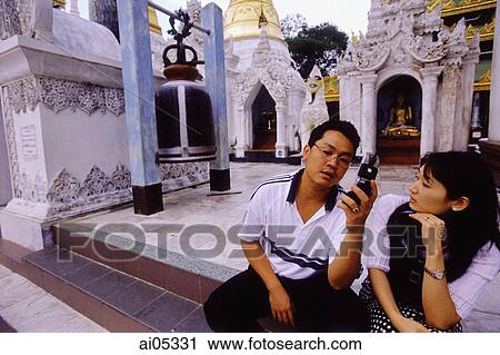 Myanmar (Burma), Yangon (Rangoon), A man making a call on his cell phone at the Shwedagon Pagoda. A privileged few are allowed to own and operate mobile phones in Myanmar. View Large Photo Image Stock Image - Myanmar (Burma), Yangon (Rangoon), A man making a call on his cell phone at the Shwedagon Pagoda. A privileged few are allowed to own and operate mobile phones in Myanmar.. Fotosearch